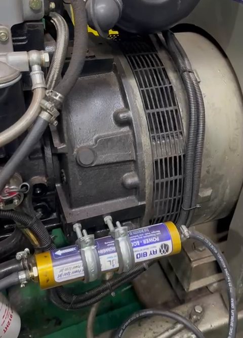Diesel generator in a ship's engine room with the unit fitted in its fuel line.